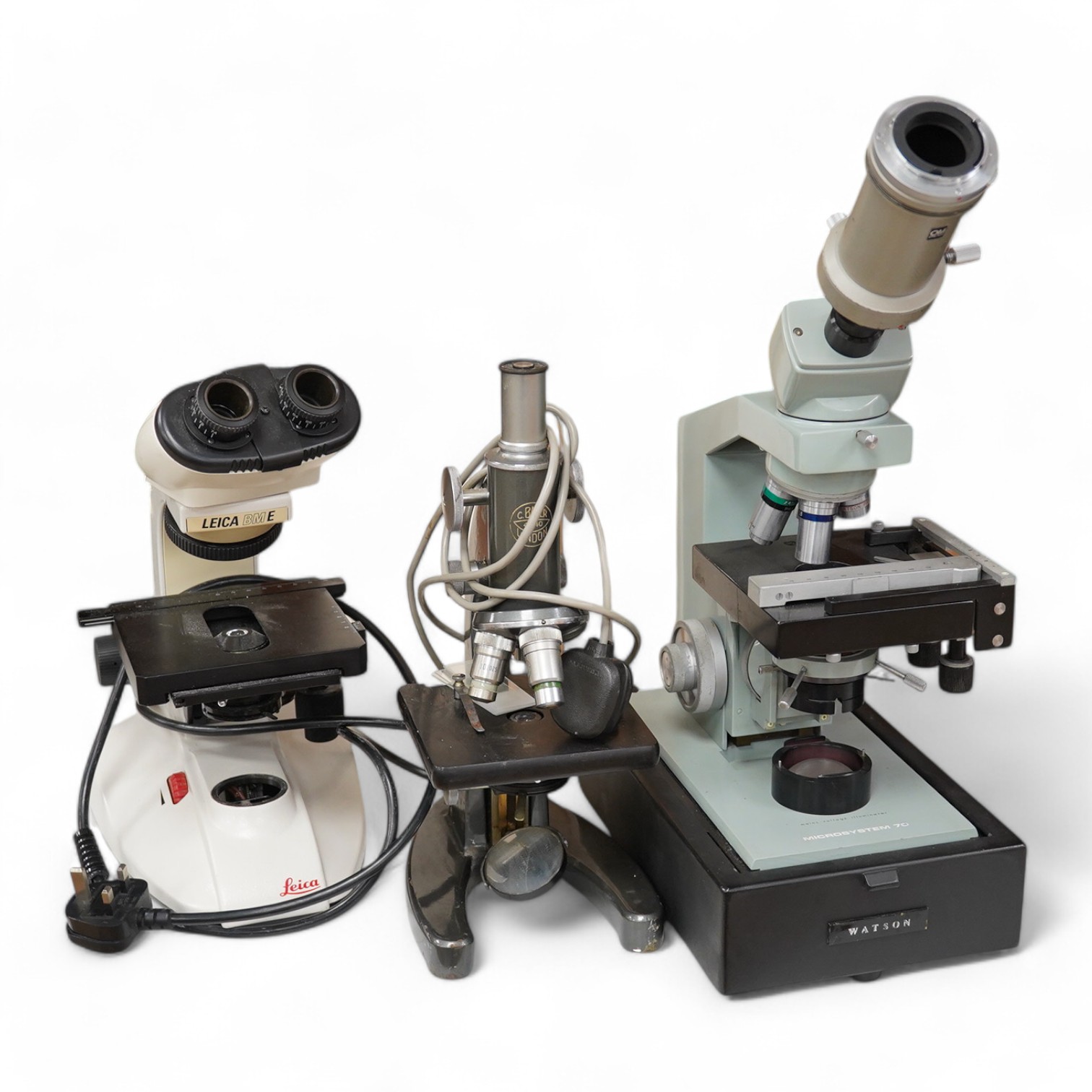 Three mid twentieth century microscopes; a Leica BM E binocular microscope, a Watson Microsystem 70 and a C. Baker, London, No.41840. Condition - fair.